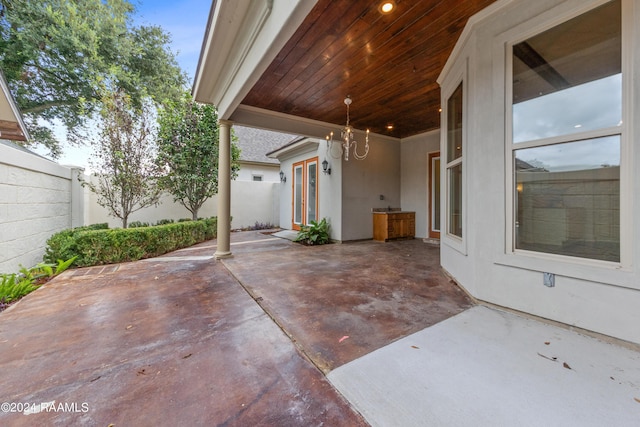 view of patio with french doors and a fenced backyard