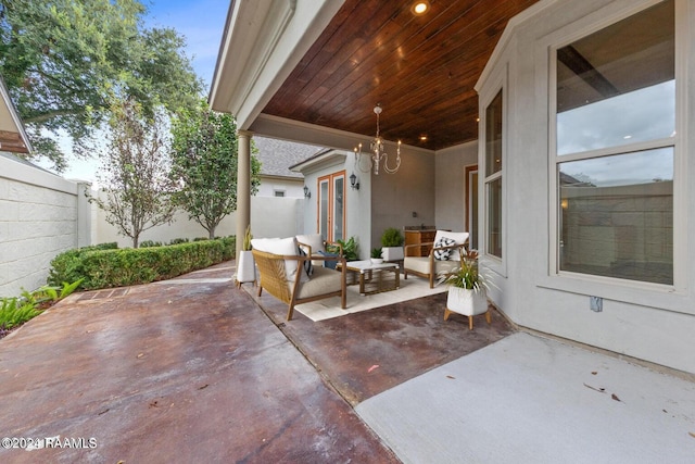 view of patio with an outdoor living space and fence