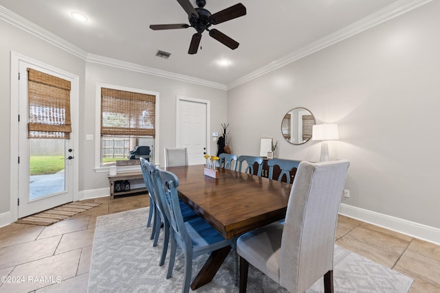 tiled dining area featuring ceiling fan and crown molding