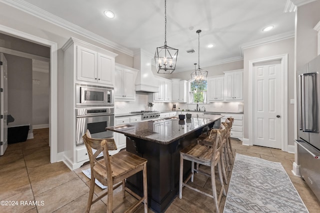 kitchen featuring appliances with stainless steel finishes, custom range hood, a kitchen island, and backsplash