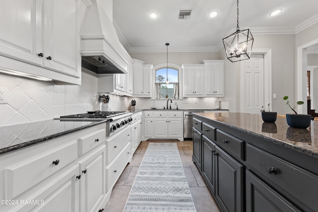 kitchen featuring white cabinets, light tile patterned floors, custom exhaust hood, and tasteful backsplash