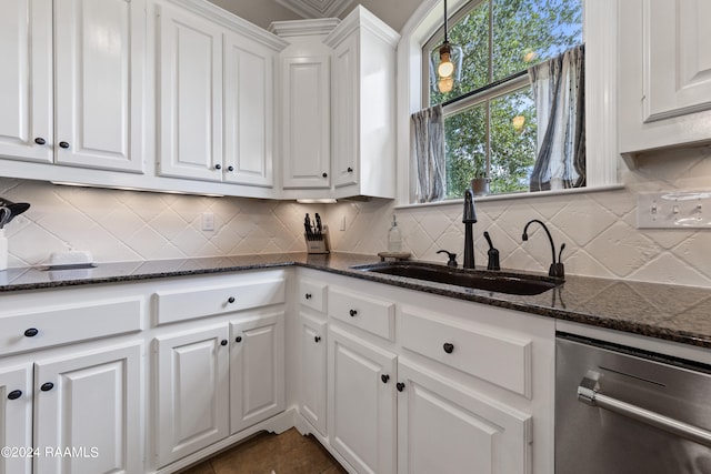 kitchen featuring white cabinets, sink, tasteful backsplash, and stainless steel dishwasher