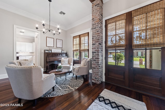 living room featuring french doors, an inviting chandelier, dark hardwood / wood-style flooring, and brick wall