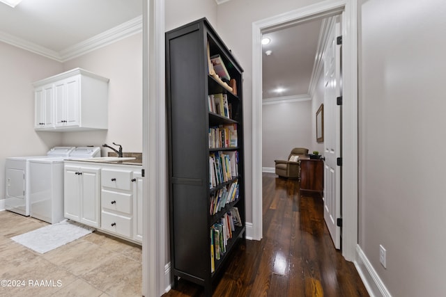 hall with crown molding, sink, separate washer and dryer, and wood-type flooring