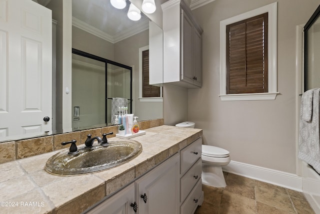 bathroom featuring a shower with door, vanity, tile patterned flooring, crown molding, and toilet