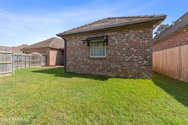 rear view of property with a lawn