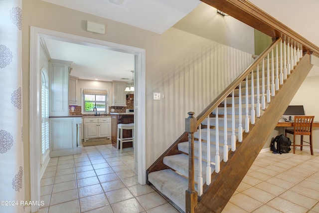 stairs featuring tile patterned flooring and baseboards