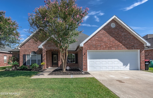 view of property with a garage and a front yard