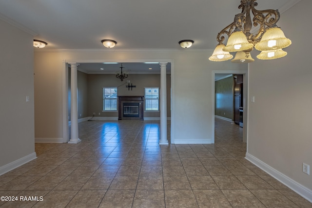 unfurnished living room with tile patterned flooring, ornamental molding, an inviting chandelier, and ornate columns