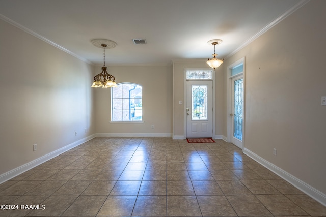 tiled foyer entrance featuring an inviting chandelier and crown molding