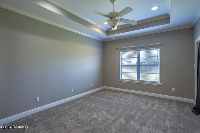 empty room featuring crown molding, a raised ceiling, ceiling fan, and carpet floors