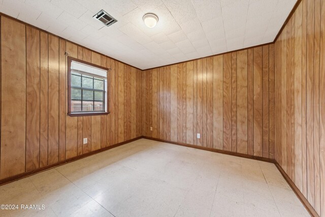 tiled empty room with wooden walls