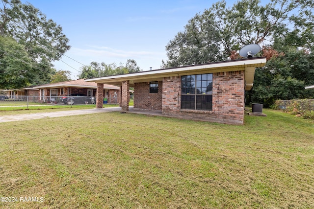 ranch-style home featuring central AC and a front lawn