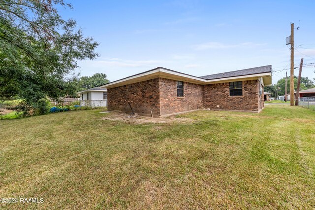 rear view of house with a lawn