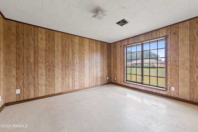 spare room featuring wooden walls