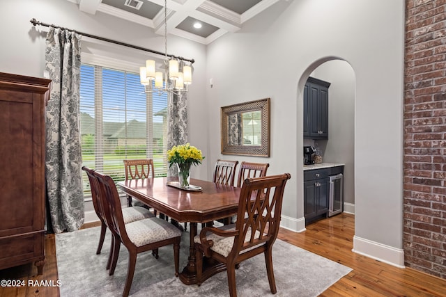 dining room featuring coffered ceiling, beverage cooler, beam ceiling, a chandelier, and hardwood / wood-style flooring