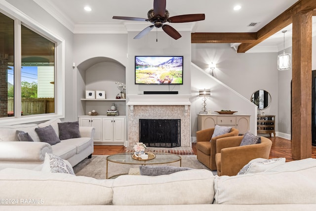 living room with ceiling fan and ornamental molding