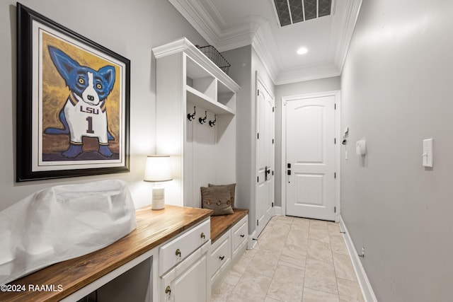 mudroom with ornamental molding and light tile patterned flooring