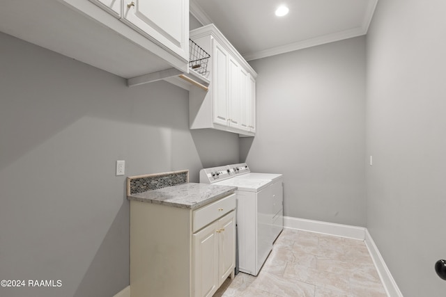 laundry area with cabinets, light tile patterned floors, crown molding, and washer and clothes dryer