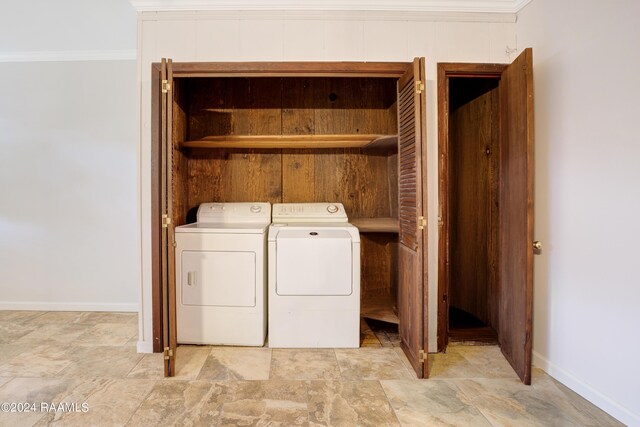 clothes washing area with crown molding and washer and dryer