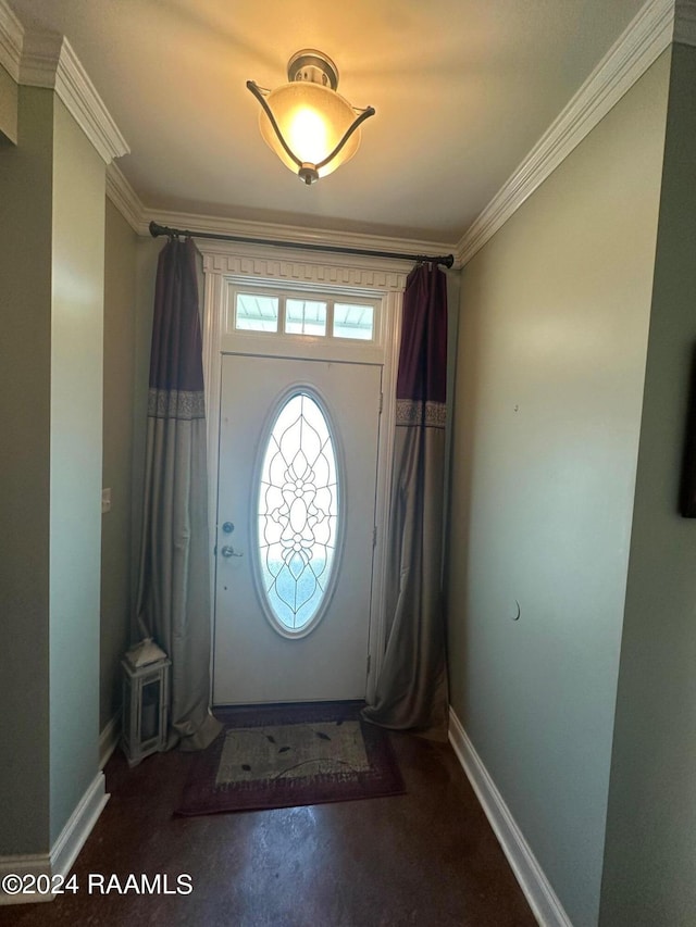 entryway with ornamental molding and concrete flooring