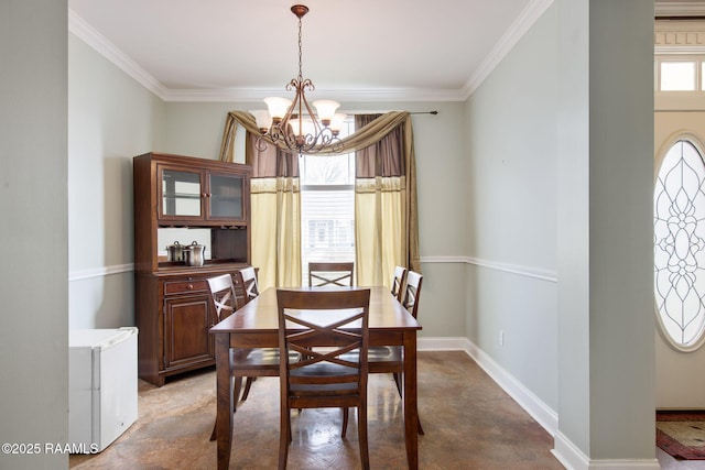 dining area featuring ornamental molding and a chandelier