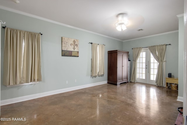 empty room featuring crown molding, concrete floors, and french doors