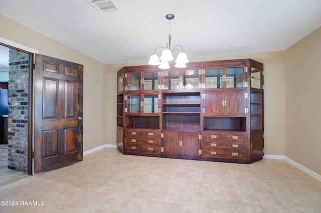 interior space with baseboards, visible vents, and an inviting chandelier