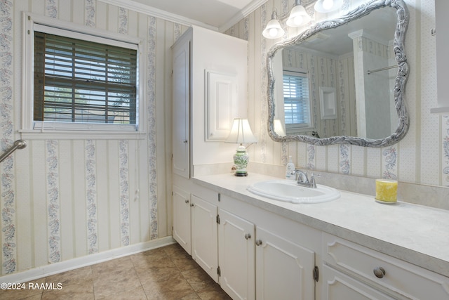 bathroom with crown molding, vanity, and tile patterned flooring