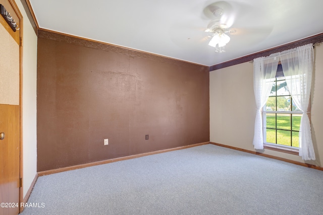 unfurnished room featuring carpet flooring, ceiling fan, and crown molding