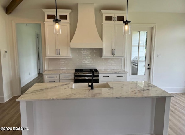 kitchen featuring beamed ceiling, white cabinets, wood-type flooring, and custom range hood