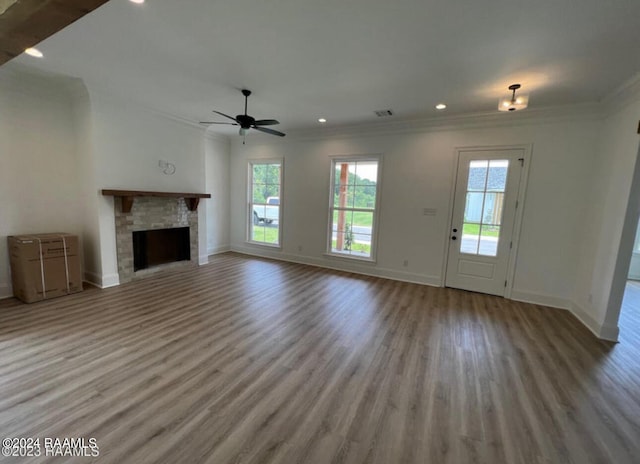 unfurnished living room featuring hardwood / wood-style floors, ceiling fan, and crown molding