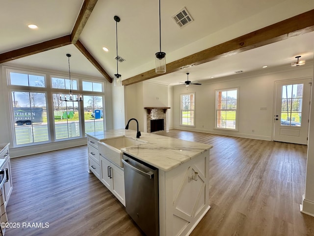 kitchen with visible vents, open floor plan, a fireplace, stainless steel dishwasher, and a sink