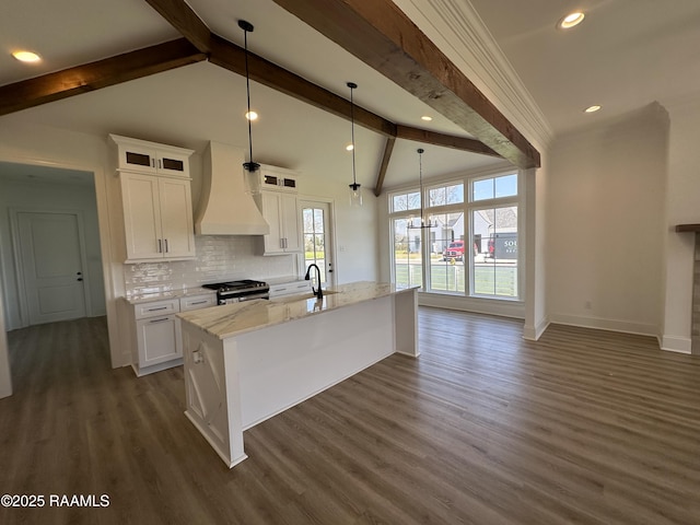 kitchen featuring custom range hood, a sink, tasteful backsplash, white cabinets, and stainless steel range with gas stovetop