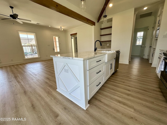 kitchen featuring light wood finished floors, visible vents, a sink, stainless steel appliances, and open shelves