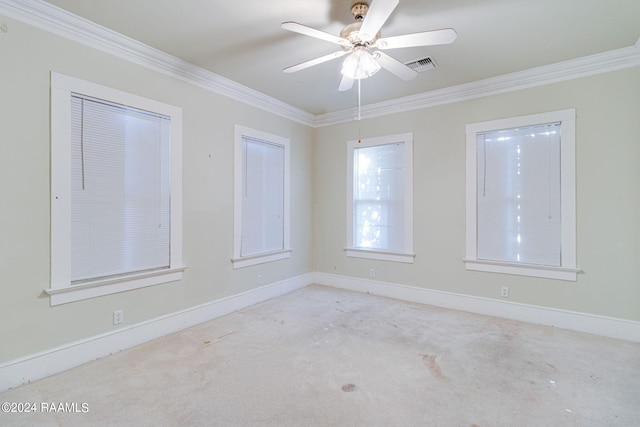 carpeted empty room with crown molding and ceiling fan