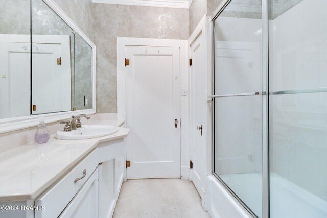 bathroom with shower / bath combination with glass door and vanity