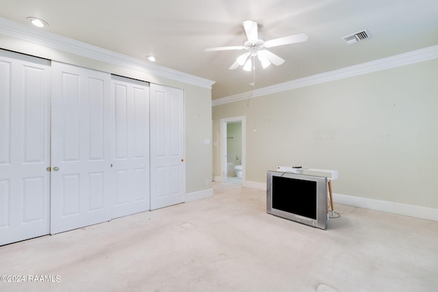 unfurnished bedroom featuring crown molding, ceiling fan, and light colored carpet