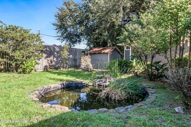 view of yard featuring a small pond