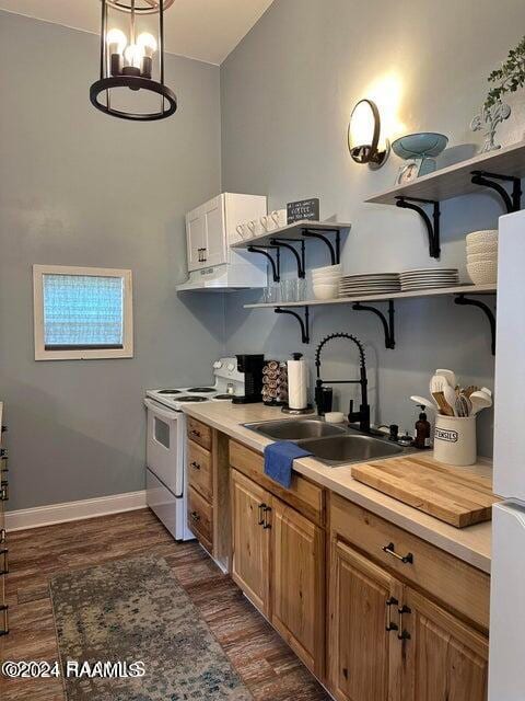 kitchen featuring dark wood-type flooring, a notable chandelier, sink, and white appliances