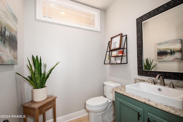 bathroom with tile patterned flooring, vanity, and toilet