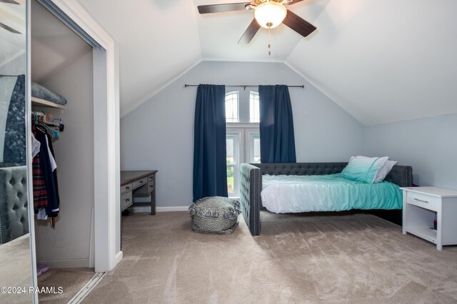 bedroom featuring vaulted ceiling, a closet, ceiling fan, and carpet floors