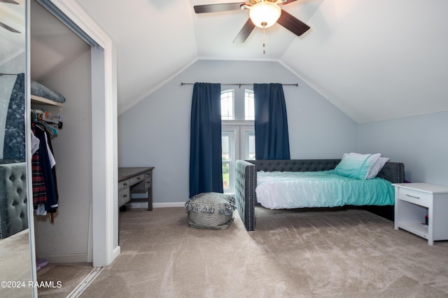 carpeted bedroom featuring vaulted ceiling, a ceiling fan, and baseboards