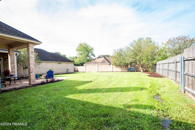 view of yard with a fenced backyard and a patio