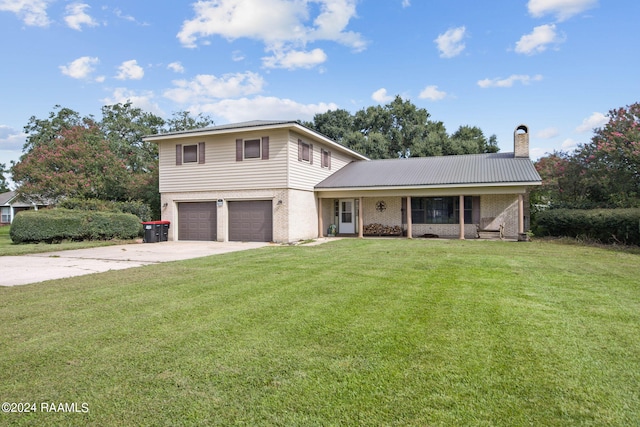 view of front of house featuring a front yard and a garage