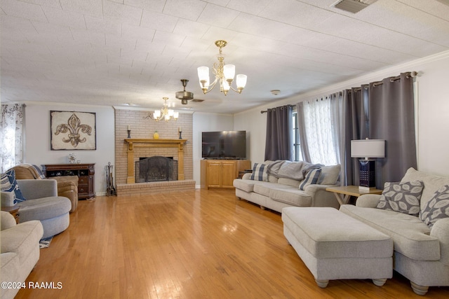 living room with ornamental molding, a brick fireplace, hardwood / wood-style flooring, and a healthy amount of sunlight