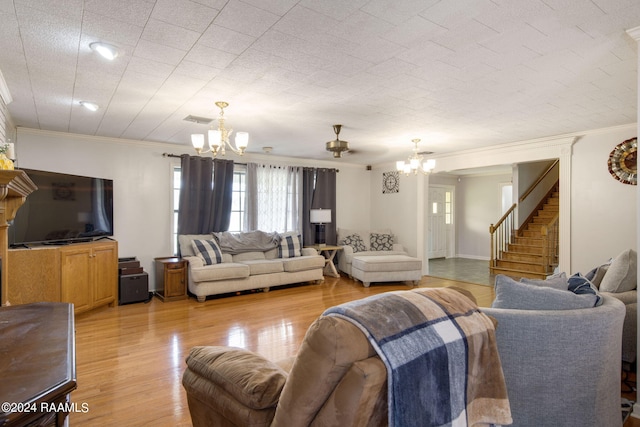 living room featuring light hardwood / wood-style flooring, ceiling fan with notable chandelier, and crown molding