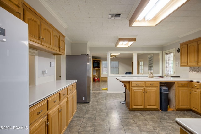 kitchen featuring backsplash, stainless steel refrigerator, light tile patterned flooring, crown molding, and white refrigerator with ice dispenser