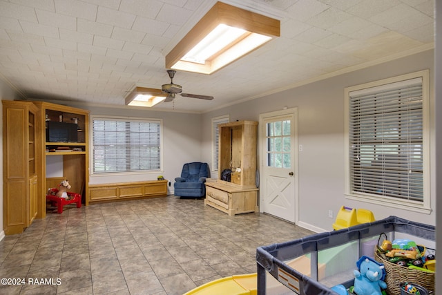 interior space with crown molding and ceiling fan