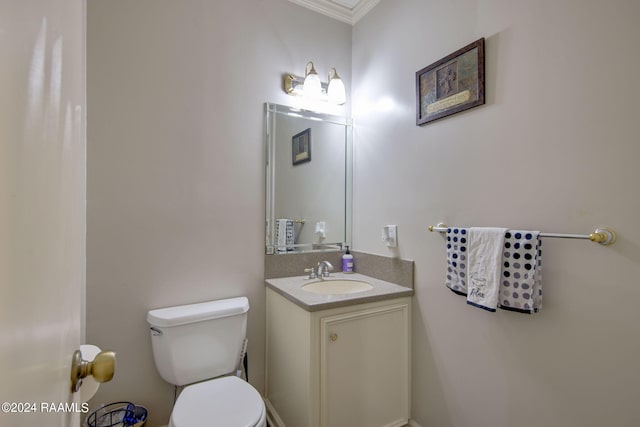 bathroom with toilet, crown molding, and vanity